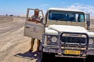 Dennis Sizemore standing next to a truck in Botswana, Africa.