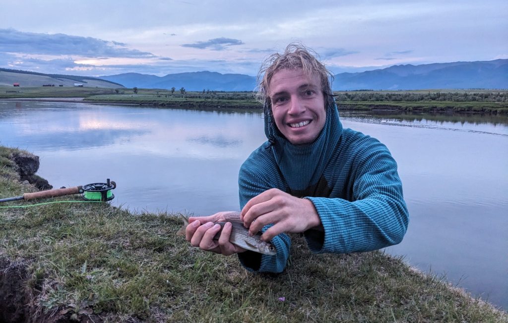 TJ with a fish he caught while fly fishing in the Darhad. Photo: C. Smith